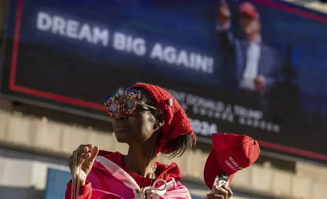 A vendor shows merchandise in support of Republican presidential nominee former President Donald Trump during his campaign rally outside Madison Square Garden, Sunday, Oct. 27, 2024, in New York. (AP Photo/Yuki Iwamura)