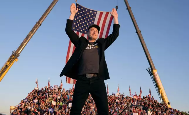 Tesla and SpaceX CEO Elon Musk walks to the stage to speak alongside Republican presidential nominee former President Donald Trump at a campaign event at the Butler Farm Show, Saturday, Oct. 5, 2024, in Butler, Pa. (AP Photo/Alex Brandon)