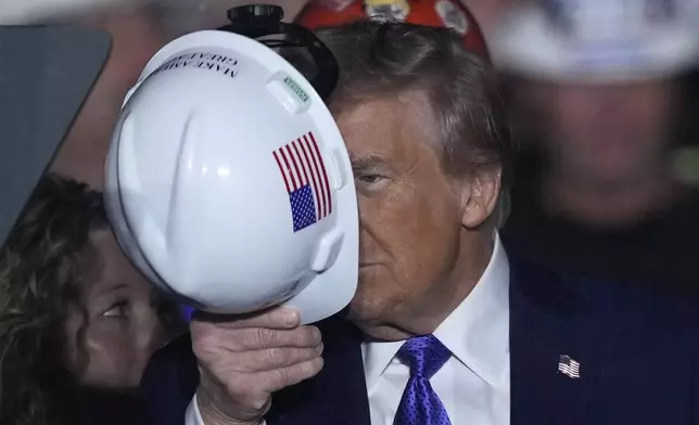 Republican presidential nominee former President Donald Trump stands on stage with steelworkers as he speaks at a campaign rally, Saturday, Oct. 19, 2024, at Arnold Palmer Regional Airport in Latrobe, Pa. (AP Photo/Matt Rourke)