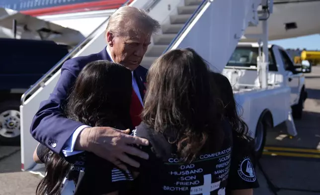 Republican presidential nominee former President Donald Trump greets family members of Corey Comperatore as he arrives at Pittsburgh International Airport en route to speak at a campaign rally at the Butler Farm Show, Saturday, Oct. 5, 2024, in Pittsburgh. (AP Photo/Evan Vucci)