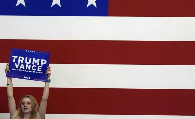 A supporter listens as Republican presidential nominee former President Donald Trump speaks at a campaign rally at Williams Arena at Mignes Coliseum, Monday, Oct. 21, 2024, in Greenville, N.C. (AP Photo/Julia Demaree Nikhinson)