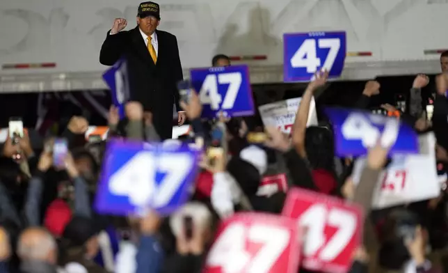 Republican presidential nominee former President Donald Trump greets the crowd at a campaign event Friday, Oct. 25, 2024, in Traverse City, Mich. (AP Photo/Paul Sancya)