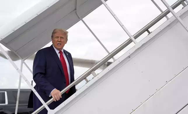 Republican presidential nominee former President Donald Trump boards his plane at West Palm Beach International Airport, Saturday, Oct. 5, 2024, in West Palm Beach, Fla., as he travels to a campaign rally in Butler, Pa. (AP Photo/Evan Vucci)