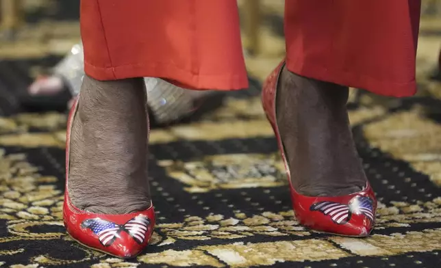 An attendee wears patriotic shoes to the roundtable of Latino leaders with Republican presidential nominee, former President Donald Trump, Tuesday, Oct. 22, 2024, in Doral, Fla. (AP Photo/Alex Brandon)