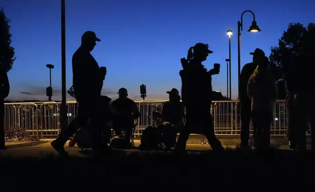 Supporters wait in line before Republican presidential nominee former President Donald Trump speaks at a campaign rally at the Findlay Toyota Arena Sunday, Oct. 13, 2024, in Prescott Valley, Ariz. (AP Photo/Ross D. Franklin)