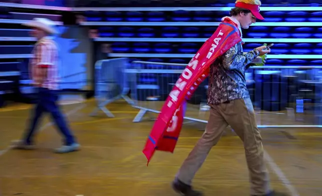 A supporter of Republican presidential nominee former President Donald Trump arrives to a campaign rally at Minges Coliseum, Monday, Oct. 21, 2024, in Greenville, N.C. (AP Photo/Julia Demaree Nikhinson)