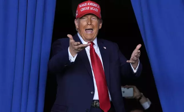 Republican presidential nominee former President Donald Trump arrives to speak during a campaign rally at Dodge County Airport, Sunday, Oct. 6, 2024, in Juneau, Wis. (AP Photo/Julia Demaree Nikhinson)