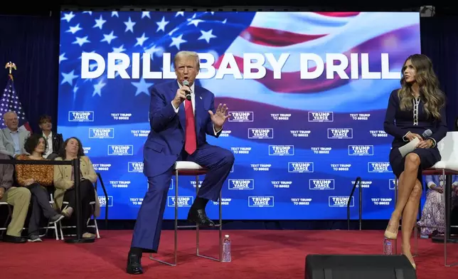 Republican presidential nominee former President Donald Trump speaks at a campaign town hall at the Greater Philadelphia Expo Center &amp; Fairgrounds, Monday, Oct. 14, 2024, in Oaks, Pa., as moderator South Dakota Gov. Kristi Noem listens. (AP Photo/Alex Brandon)