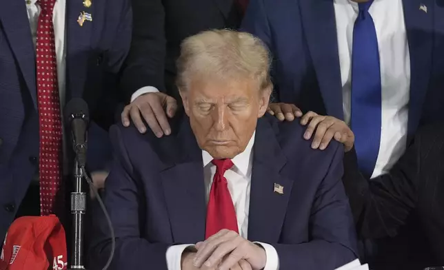 Latino leaders pray with Republican presidential nominee former President Donald Trump as he participates in a Latino leader roundtable, Tuesday, Oct. 22, 2024 in Doral, Fla. (AP Photo/Alex Brandon)