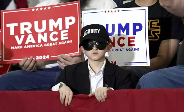 A young attendee listens as Republican vice presidential nominee Sen. JD Vance, R-Ohio, speaks at a campaign event at JWF Industries, Saturday, Oct. 12, 2024, in Johnstown, Pa. (AP Photo/Matt Freed)