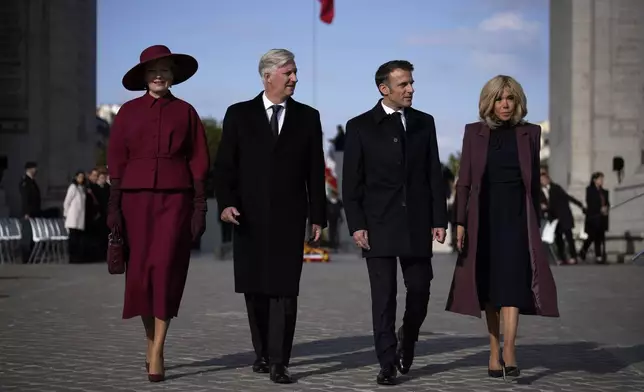 French President Emmanuel Macron, center right, his wife Brigitte, Belgium's King Philippe and Queen Mathilde attend a ceremony at the Arc de Triomphe in Paris, Monday, Oct. 14, 2024. (AP Photo/Louis Delmotte)