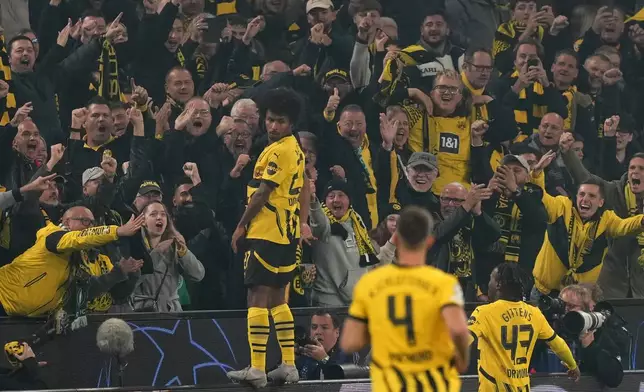 Dortmund's Karim Adeyemi celebrates with the fans his side's second goal during the Champions League opening phase soccer match between Borussia Dortmund and Celtic FC at the BVB Stadion in Dortmund, Germany, Tuesday, Oct. 1, 2024. (AP Photo/Martin Meissner)