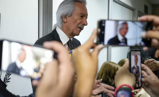 Guatemalan journalist Jose Ruben Zamora, founder of El Periodico newspaper, jailed for more than two years on money laundering charges, talks with reporters before attending a hearing to ask the judge to serve his detention at home while his judicial process continues, in Guatemala City, Friday, Oct. 18, 2024. (AP Photo/Moises Castillo)