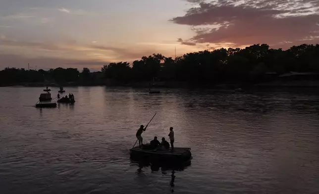 Salvadoran migrant Maria Garcia and her boyfriend cross the Suchiate River, which marks the border between Guatemala and Mexico, from Tecun Uman, Guatemala, Monday, Oct. 28, 2024. (AP Photo/Matias Delacroix)