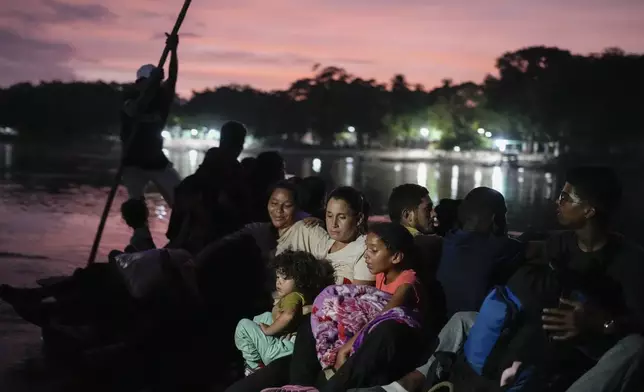 Venezuelan migrant Lisbeth Contreras hugs her children as she crosses the Suchiate River, which marks the border between Guatemala and Mexico, from Tecun Uman, Guatemala, Saturday, Oct. 26, 2024. (AP Photo/Matias Delacroix)