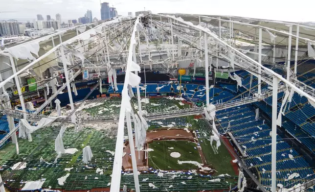 The roof of the Tropicana Field is damaged the morning after Hurricane Milton hit the region, Thursday, Oct. 10, 2024, in St. Petersburg, Fla. (AP Photo/Julio Cortez)