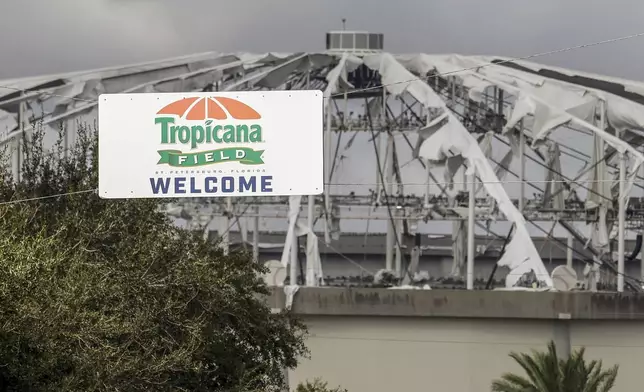 Signage at the entrance to the parking lot of Tropicana Field where the roof was torn off during Hurricane Milton on Thursday, Oct. 10, 2024, in St. Petersburg, Fla. (AP Photo/Mike Carlson)