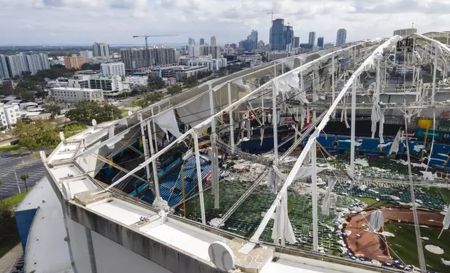 The roof of the Tropicana Field is damaged the morning after Hurricane Milton hit the region, Thursday, Oct. 10, 2024, in St. Petersburg, Fla. (AP Photo/Julio Cortez)