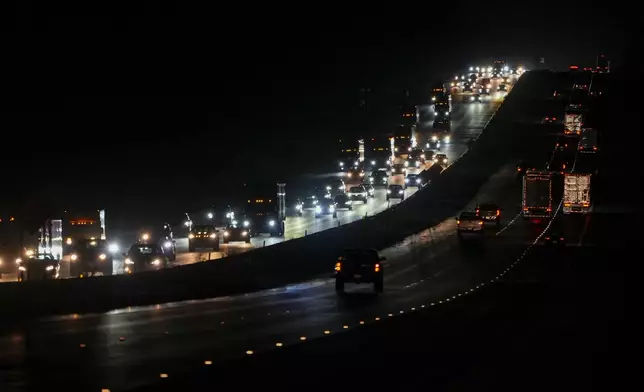 Heavy traffic flows northbound on Interstate-75 as people evacuate the Tampa Bay area ahead of Hurricane Milton's arrival late Monday, Oct. 7, 2024, in Ocala, Fla. (AP Photo/Julio Cortez)