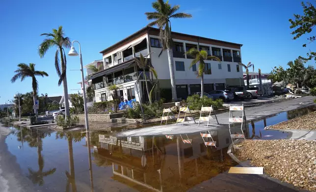 Rain flood waters recede around the bay-front home which Christian Burke's father had built to be hurricane proof and where Burke rode out Hurricane Milton along with his wife and aunt, in Gulfport, Fla., Thursday, Oct. 10, 2024. Even without the feared storm surge, Burke said the experience was intense and he won't feel the need to do it again. (AP Photo/Rebecca Blackwell)