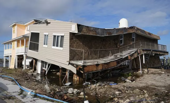 Houses lie in ruins after sustaining tornado and flood damage from Hurricane Milton, Thursday, Oct. 10, 2024, in Matlacha, Fla. (AP Photo/Marta Lavandier)