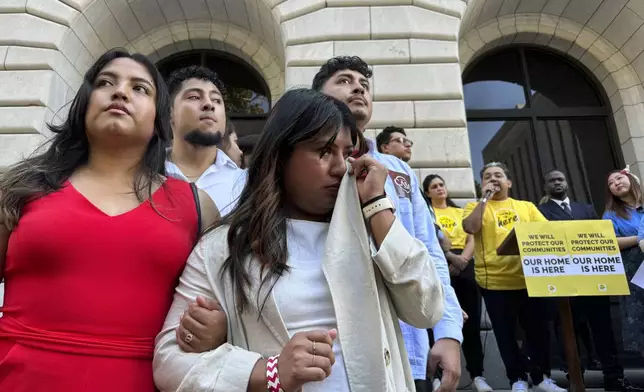 Wendy Reynoso, 24, whose DACA application remains in limbo, wipes tears during a rally outside a federal appeals court in a hearing to decide the future of the policy, in New Orleans, Thursday, Oct. 10, 2024. (AP Photo/Jack Brook)