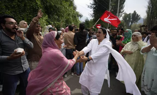 Supporters of Indian National Congress and National Conference party celebrate early leads in election outside a counting center on the outskirts of Srinagar, Indian controlled Kashmir, Tuesday, Oct. 8, 2024. (AP Photo/Mukhtar Khan)