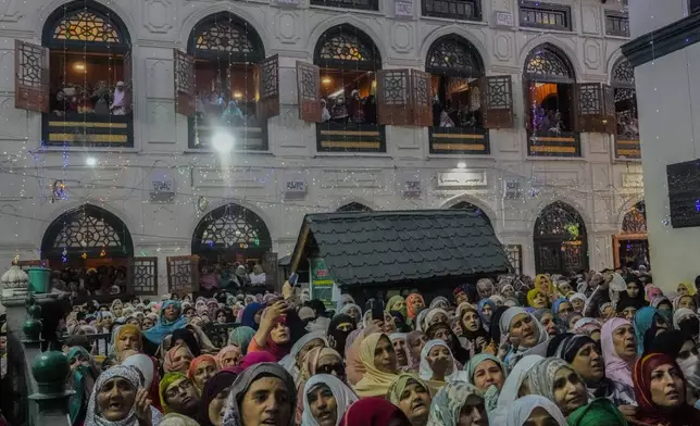 Kashmiri Muslims attend the 'urs', or death anniversary of the Sufi saint Sheikh Syed Abdul Qadir outside his shrine in Srinagar, Indian controlled Kashmir, Tuesday, Oct. 15, 2024.(AP Photo/Mukhtar Khan)