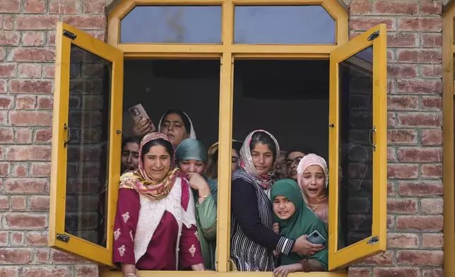 Relatives and neighbors cry as they watch the funeral of Kashmiri doctor Shahnawaz who was among those killed when gunmen fired at people working on a strategic tunnel project in Indian-controlled Kashmir, at Nadigam village, southwest of Srinagar, Monday, Oct. 21, 2024. (AP Photo/Mukhtar Khan)