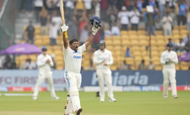 India's Sarfaraz Khan celebrates after scoring a century during the day four of the first cricket test match between India and New Zealand at the M.Chinnaswamy Stadium, in Bengaluru, India, Saturday, Oct. 19, 2024. (AP Photo/Aijaz Rahi)