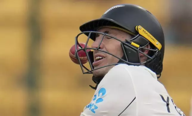 The ball hits the helmet of New Zealand's Will Young as he attempts to play a shot on a delivery by India's Ravindra Jadeja during the day five of the first cricket test match between India and New Zealand at the M.Chinnaswamy Stadium, in Bengaluru, India, Sunday, Oct. 20, 2024. (AP Photo/Aijaz Rahi)