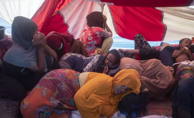 Rohingya refugees rest in their boat anchored in the waters near the coast of Labuhan Haji, Aceh province, Indonesia, Tuesday, Oct. 22, 2024. (AP Photo/Binsar Bakkara)