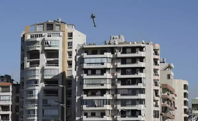 A missile launched from an Israeli jet hits a building in Ghobeiri, Beirut, Lebanon, Tuesday, Oct. 22, 2024. (AP Photo/Bilal Hussein)