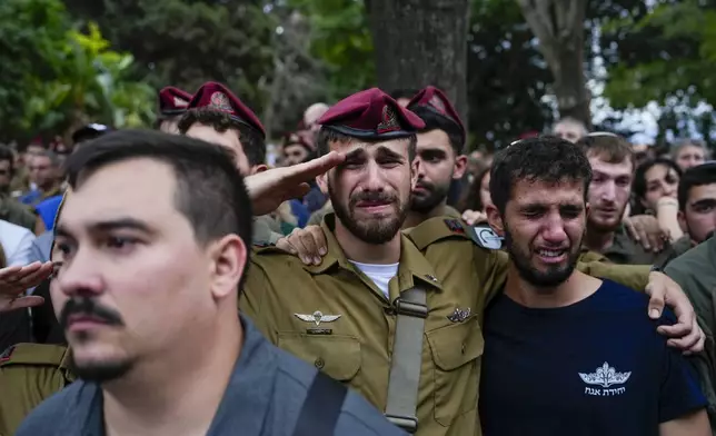 Mourners attend the funeral of Sgt. First Class Nazar Itkin who was killed during Israel's ground operation against Hezbollah militants in Lebanon, in Kiryat Ata, Israel, Sunday, Oct. 6, 2024. (AP Photo/Baz Ratner)