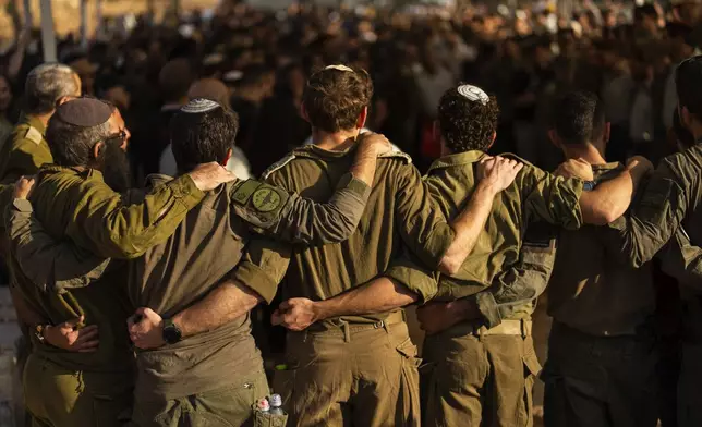 Israeli soldiers mourn during the funeral of reservist Yedidia Bloch, 31, at Mevo Horon settlement, West Bank, Wednesday, Oct. 30, 2024. Bloch died on Tuesday 29 after he was injured in Lebanon. (AP Photo/Francisco Seco)