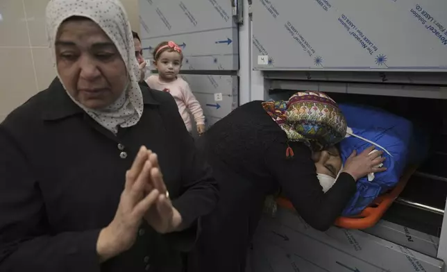 Relatives of Palestinian Husam Mallah, 28, take the last look at his body in the morgue of a local hospital, in the West Bank city of Tulkarem, Thursday, Oct. 31, 2024. (AP Photo/Nasser Nasser)