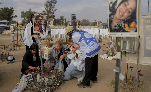 Peopls visit the site of the Nova music festival, where hundreds of revelers were killed and abducted by Hamas, on the eve of the one-year anniversary of the attack, near Kibbutz Reim, southern Israel, Sunday, Oct. 6, 2024. (AP Photo/Ohad Zwigenberg)