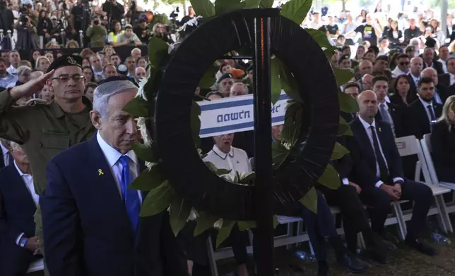 Israel's Prime Minister Benjamin Netanyahu takes part in a ceremony marking the Hebrew calendar anniversary of the Hamas attack on October 7 last year that sparked the ongoing war in Gaza, at the Mount Herzl military cemetery in Jerusalem, Israel Sunday Oct. 27, 2024. (Gil Cohen-Magen/Pool Photo via AP)