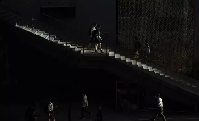 People walk through Miyashita Park on Tuesday, Oct. 1, 2024, in Tokyo. (AP Photo/Andy Bao)