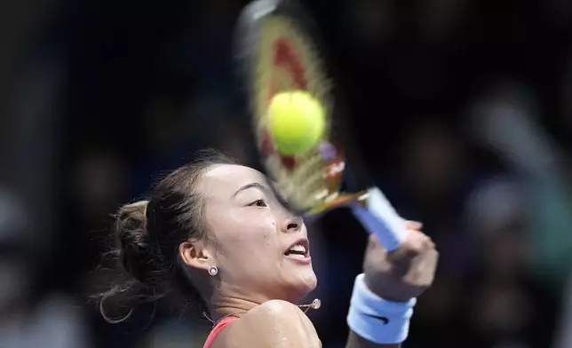 China's Zheng Qinwen returns a shot against Sofia Kenin of the United States during the final match of the Pan Pacific Open women's tennis tournament at Ariake Coliseum, in Tokyo, Sunday, Oct. 27, 2024. (AP Photo/Eugene Hoshiko)