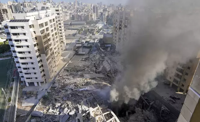 Smoke rises from the site of an Israeli airstrike in Dahiyeh, Beirut, Lebanon, Wednesday, Oct. 2, 2024. (AP Photo/Hassan Ammar)