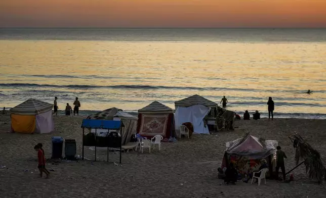 Tents set up as temporary shelters by displaced families fleeing the Israeli airstrikes in the south and Dahiyeh, are seen along the Ramlet al-Baida public beach in Beirut, Lebanon, Tuesday Oct. 8, 2024. (AP Photo/Bilal Hussein)