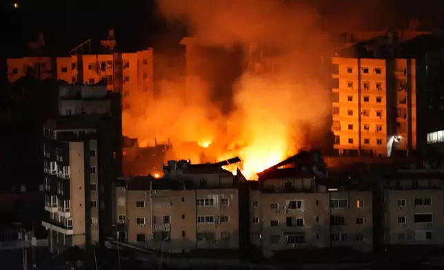 Flame and smoke rises from buildings hit by Israeli airstrikes on Dahiyeh, in the southern suburb of Beirut, Wednesday, Oct. 23, 2024. (AP Photo/Hussein Malla)