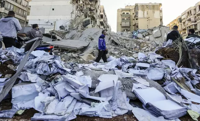 Documents of Hezbollah-run al-Qard al-Hassan are scattered at the site of an Israeli airstrike on Sunday night in Beirut's southern suburb, Lebanon, Monday, Oct. 21, 2024. (AP Photo/Hassan Ammar)