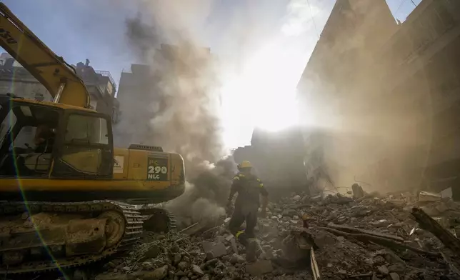 Rescue workers search for victims at the site of Thursday's Israeli airstrike in Beirut, Lebanon, Friday, Oct. 11, 2024. (AP Photo/Hassan Ammar)