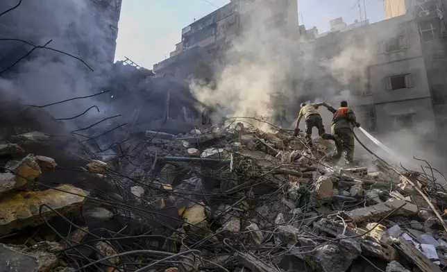 Rescue workers search for victims at the site of Thursday's Israeli airstrike in Beirut, Lebanon, Friday, Oct. 11, 2024. (AP Photo/Hassan Ammar)