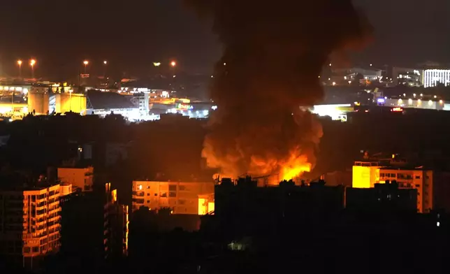 Flames and smoke rise from an Israeli airstrike in Dahiyeh, Beirut, Lebanon, early Sunday, Oct. 6, 2024. (AP Photo/Hussein Malla)