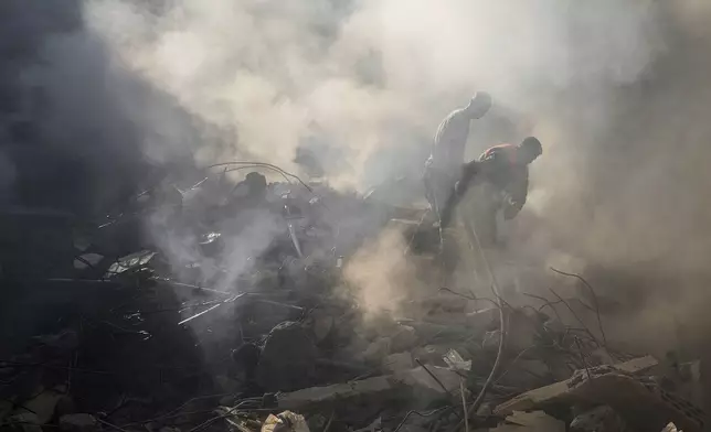 Rescue workers search for victims at the site of Thursday's Israeli airstrike in Beirut, Lebanon, Friday, Oct. 11, 2024. (AP Photo/Hassan Ammar)