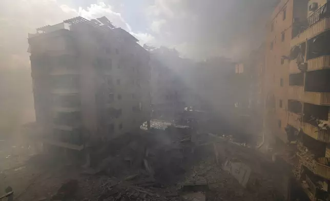 Smoke envelops the area near destroyed buildings at the site of an Israeli airstrike in Dahiyeh, Beirut, Lebanon, Wednesday, Oct. 2, 2024. (AP Photo/Hassan Ammar)