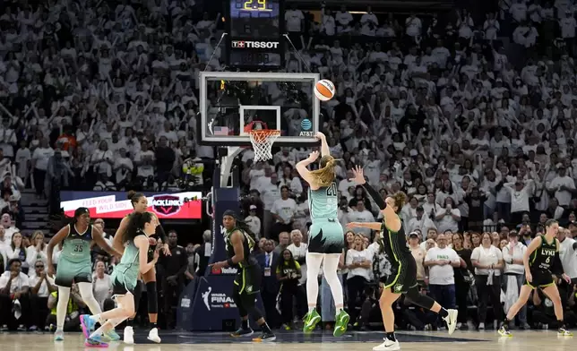 New York Liberty guard Sabrina Ionescu (20) makes a 3-point basket during the second half against the Minnesota Lynx in Game 3 of a WNBA basketball final playoff series, Wednesday, Oct. 16, 2024, in Minneapolis. The Liberty won 80-77. (AP Photo/Abbie Parr)